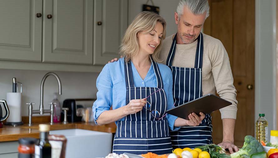 Couple looking at recipe on iPad