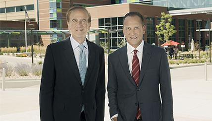 Dr Michael Salem and Evan Zucker standing in front of the center for outpatient health