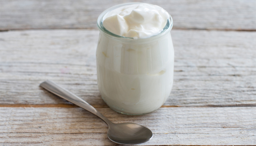 Plain greek yogurt in a small jar