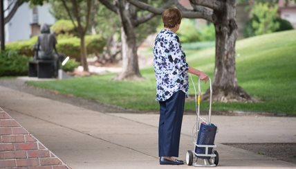 Woman walking with oxygen tank