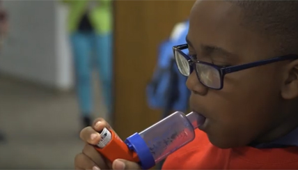 Young child using an inhaler