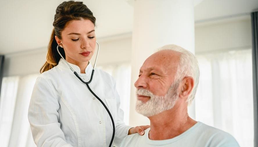 Doctor listening to mans heart