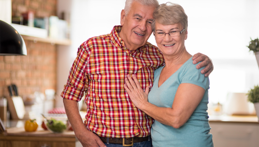 Couple standing in kitchen