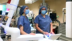 National Jewish Health and Saint Joseph Hospital interventional pulmonologists Kristen Glisinski, MD, left, and Ellen Volker, MD, use robotic bronchoscopy to obtain tissue samples deep within a patient's lung.