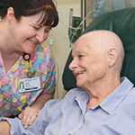 A patient with a nurse receiving an infusion for cancer treatment