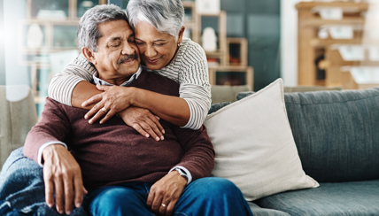 COVID-19 (Coronavirus) & Cancer: Couple hugging on couch